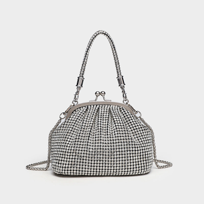 Compact all-over rhinestone kiss-lock evening bag with silver-tone metal frame, rhinestone top handle, and detachable chain