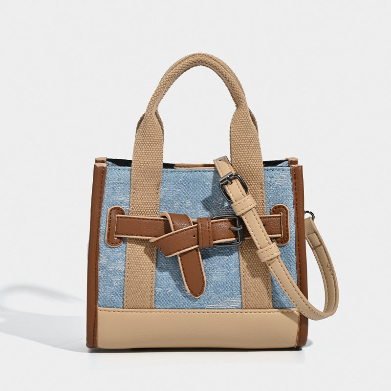 Structured mini tote bag in washed denim and neutral colorblock with brown leather-look trim and front belt buckle detail