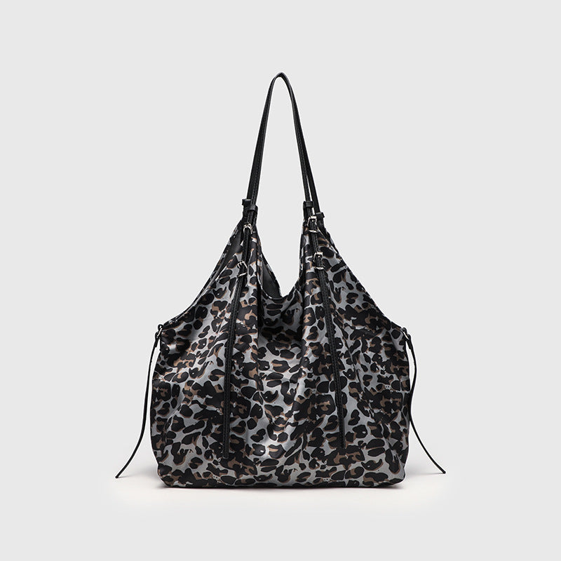 Large leopard-print slouchy tote shoulder bag in grey, black, and tan with gold-tone hardware and adjustable leather-look