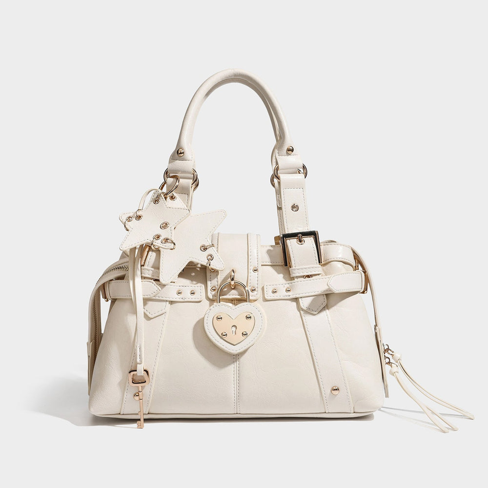Structured espresso brown Boston satchel with heart-shaped gold padlock, star charm, buckle straps, rivets, and dual top