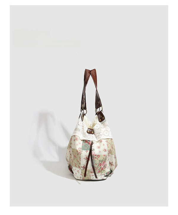 Cream floral patchwork hobo tote bag with crochet lace trim and brown leather-look shoulder straps, detail view 6