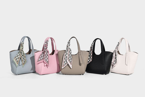 Structured pebbled leather-look tote bag with detachable scarf tie, dual top handles, and adjustable crossbody strap, detail
