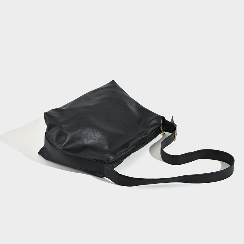 Large slouchy hobo shoulder bag in smooth black leather-look finish with gold-tone buckle hardware and adjustable strap