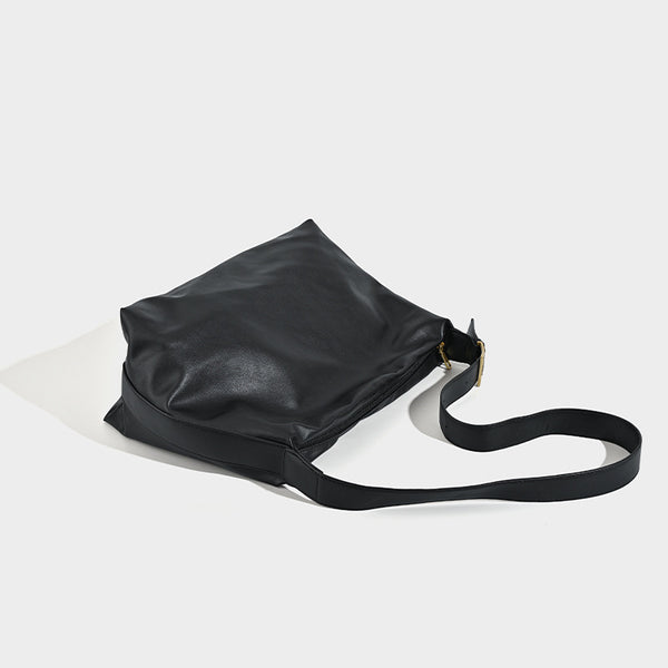 Large slouchy hobo shoulder bag in smooth black leather-look finish with gold-tone buckle hardware and adjustable strap