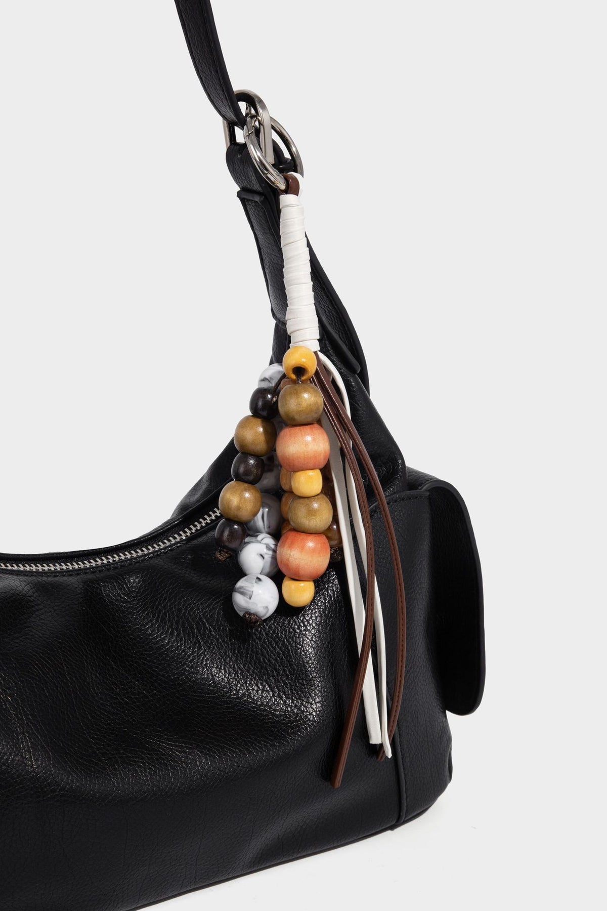 Soft pebbled leather-look hobo shoulder bag with zip top closure, side flap pockets, and silver-tone hardware, detail view 17