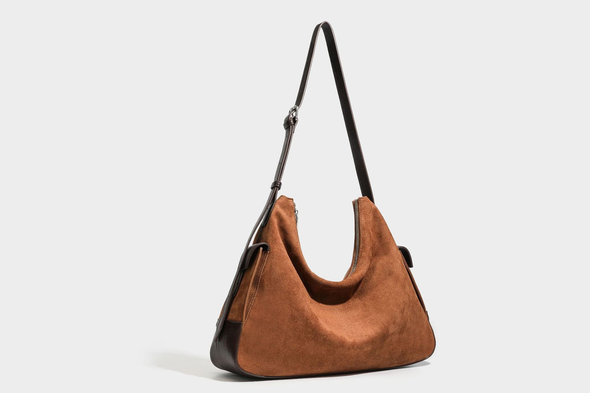 Slouchy cognac brown matte suede-look hobo shoulder bag with dark brown leather-look trim, top zip closure, front flap