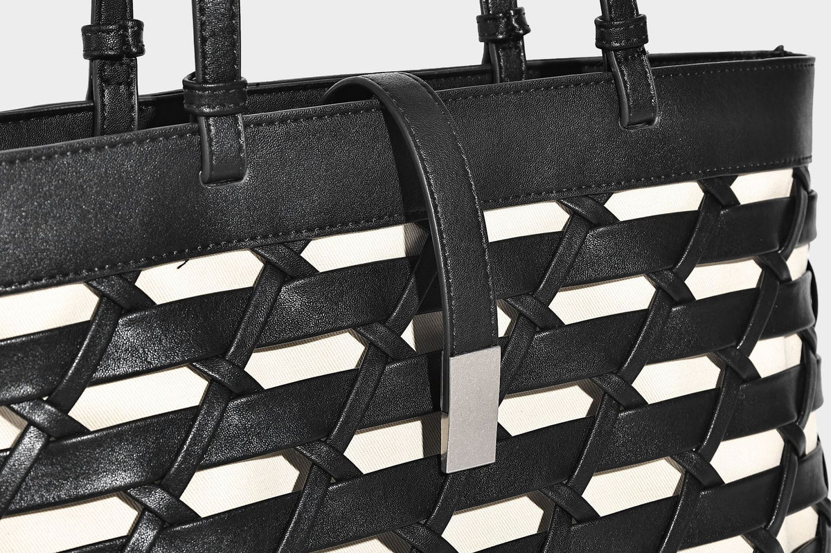 Structured woven lattice cutout tote bag with smooth leather-look trim, dual shoulder straps, and silver-tone hardware