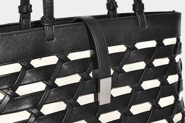Structured woven lattice cutout tote bag with smooth leather-look trim, dual shoulder straps, and silver-tone hardware