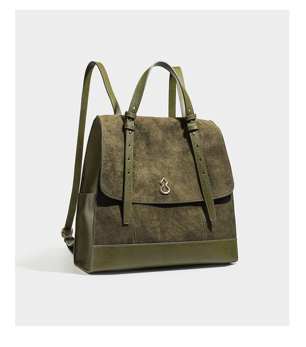 Structured suede-look convertible backpack handbag with flap closure and gold-tone emblem hardware in chocolate brown, detail