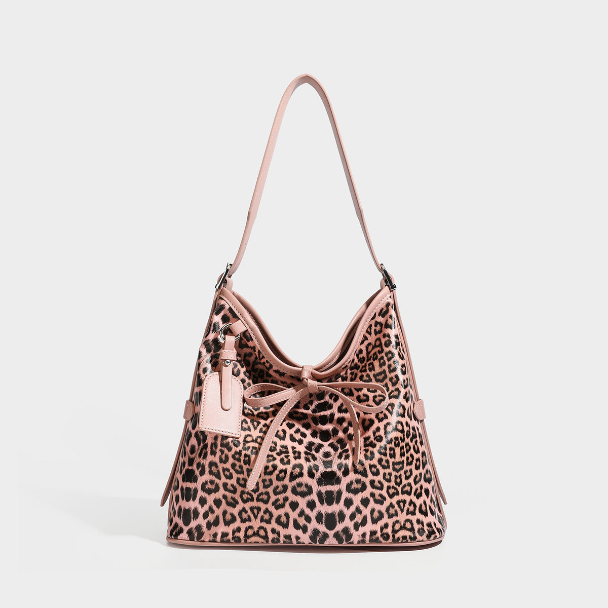 Slouchy leopard print shoulder hobo bag with black leather-look trim, tie-top closure, and single long strap, detail view 4