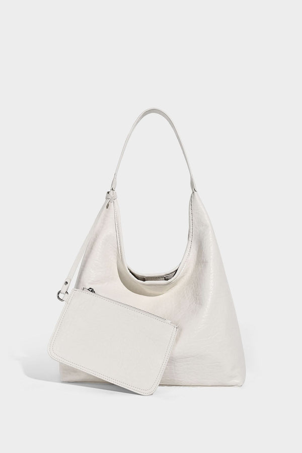 Slouchy hobo shoulder bag in pale yellow glossy pebbled leather-look finish with single shoulder strap and detachable front