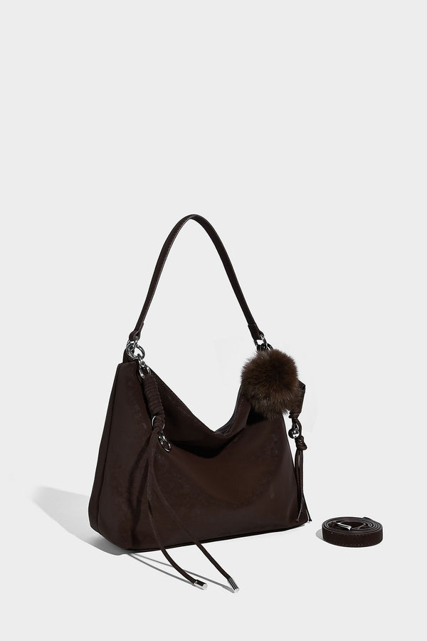 Slouchy matte-finish hobo shoulder bag with tassel cords, silver-tone hardware, and faux-fur pom charm, detail view 25