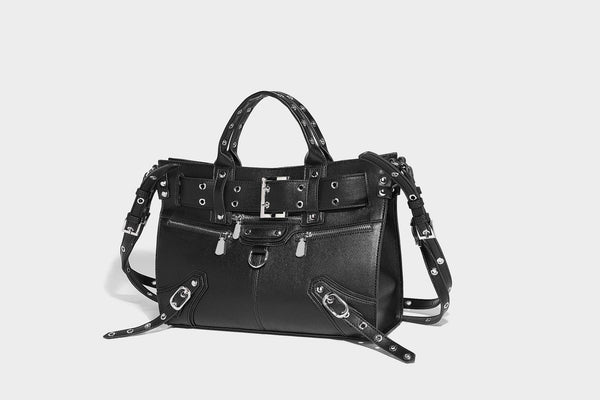 Black structured rectangular satchel bag with silver-tone rivets, large front buckle strap, zip pockets, dual top handles
