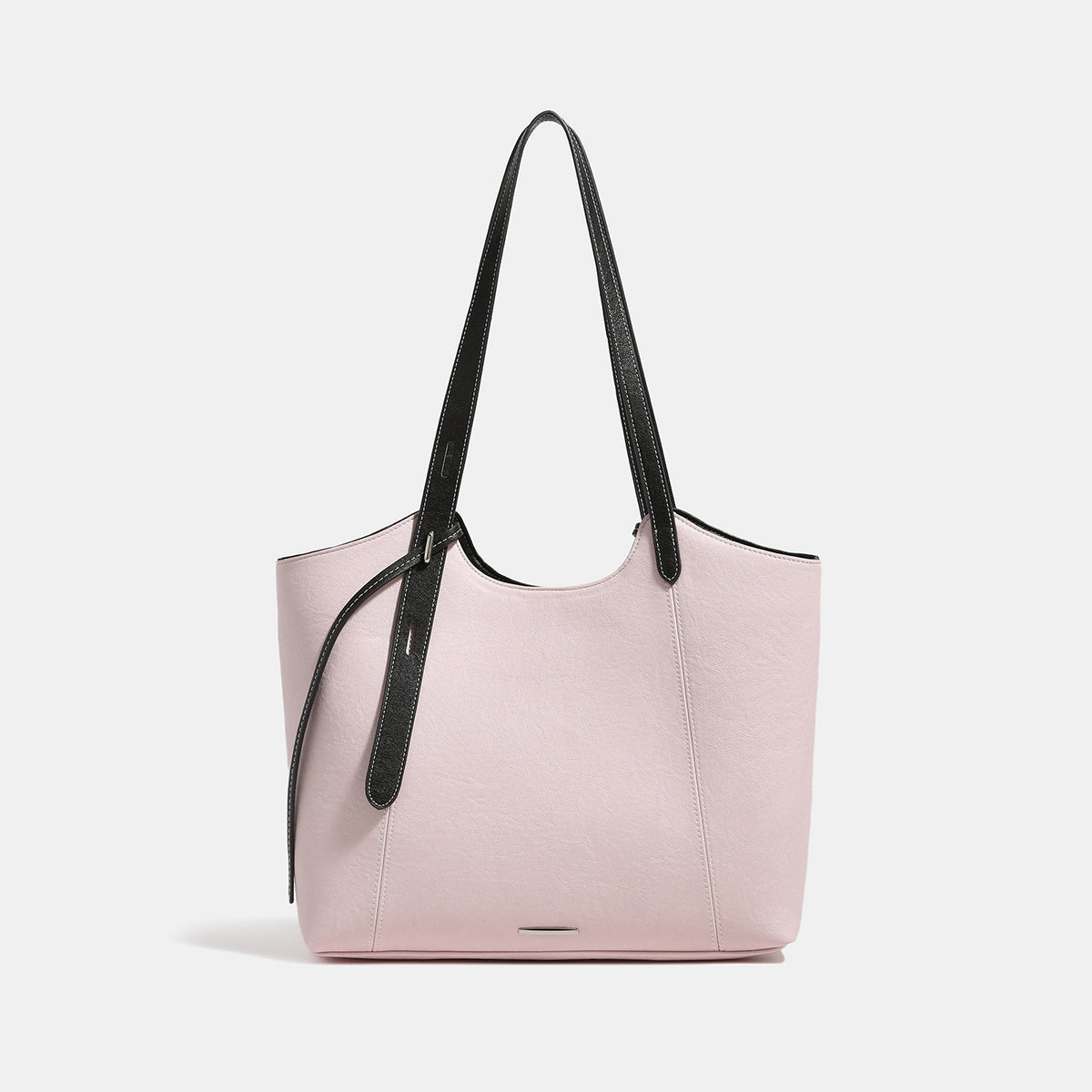 Structured trapezoidal tote bag with smooth leather-look finish, long black contrast shoulder straps, and dangling strap
