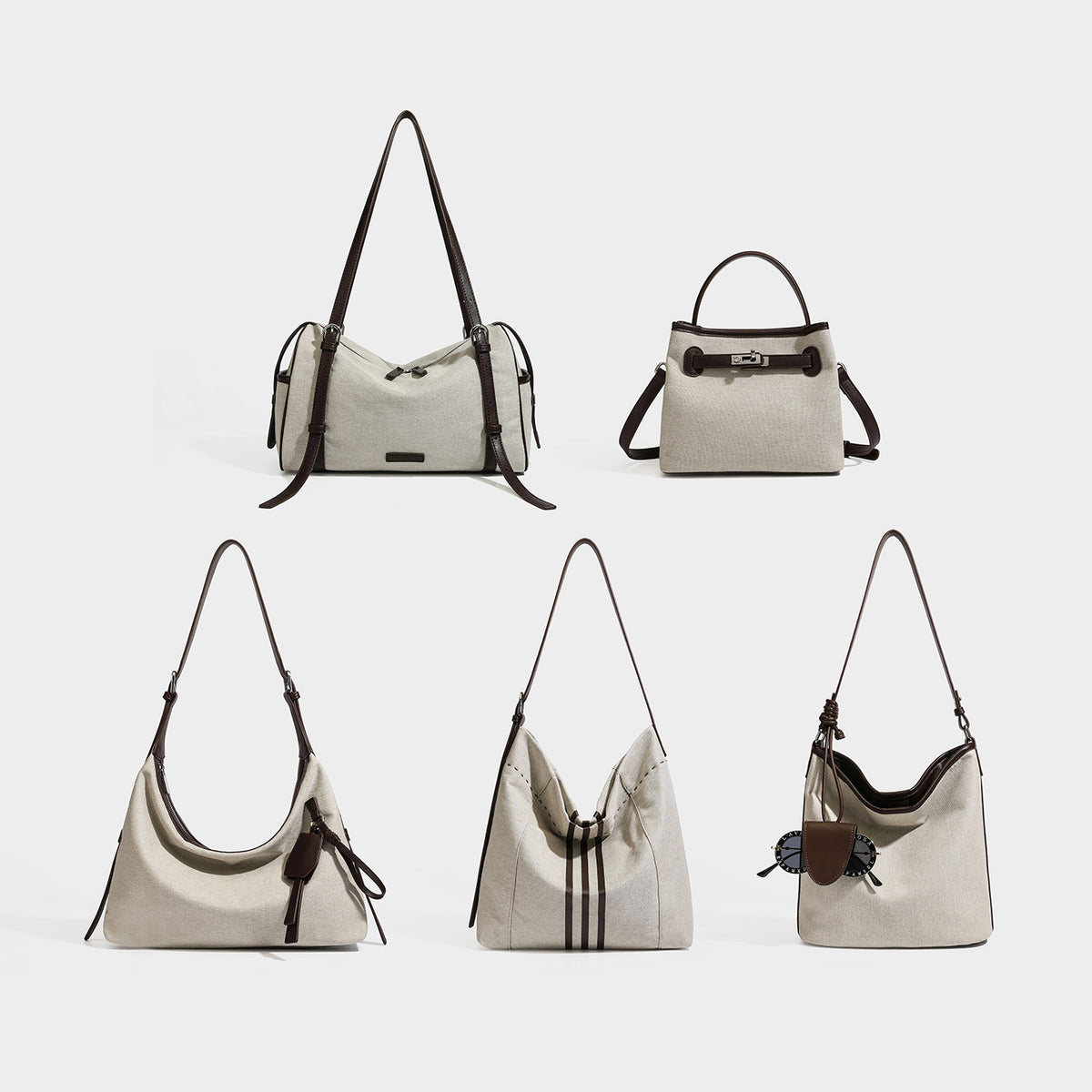 Slouchy oatmeal canvas hobo shoulder bag with dark brown leather-look trim, silver-tone zip closure, and long adjustable