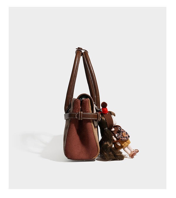 Structured color-block satchel bag in brown, rust, beige, and taupe suede-look panels with white topstitching, front buckle