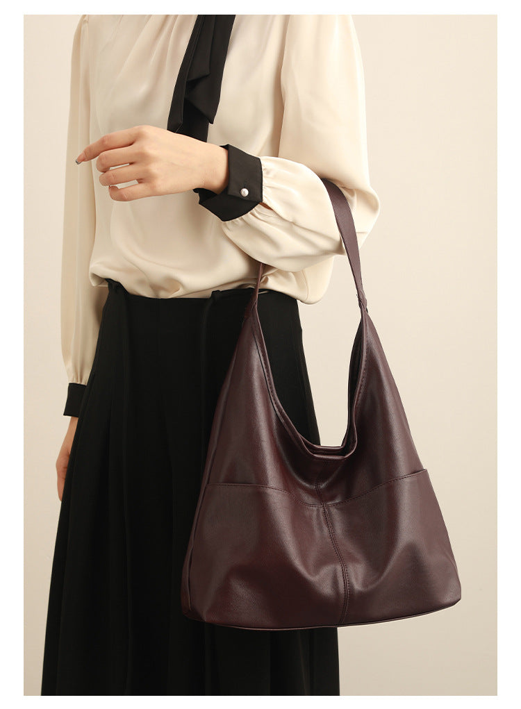 Oversized slouchy hobo tote bag in dark brown smooth matte leather-look finish with long flat shoulder strap and panelled