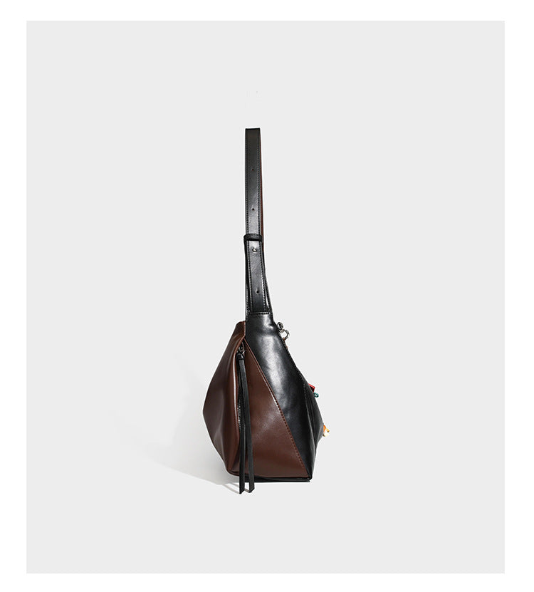 Two-tone black and brown leather-look slouchy shoulder bag with beaded tassel charm and silver-tone hardware, detail view 9