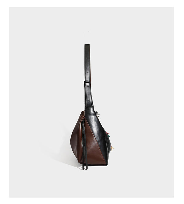 Two-tone black and brown leather-look slouchy shoulder bag with beaded tassel charm and silver-tone hardware, detail view 9