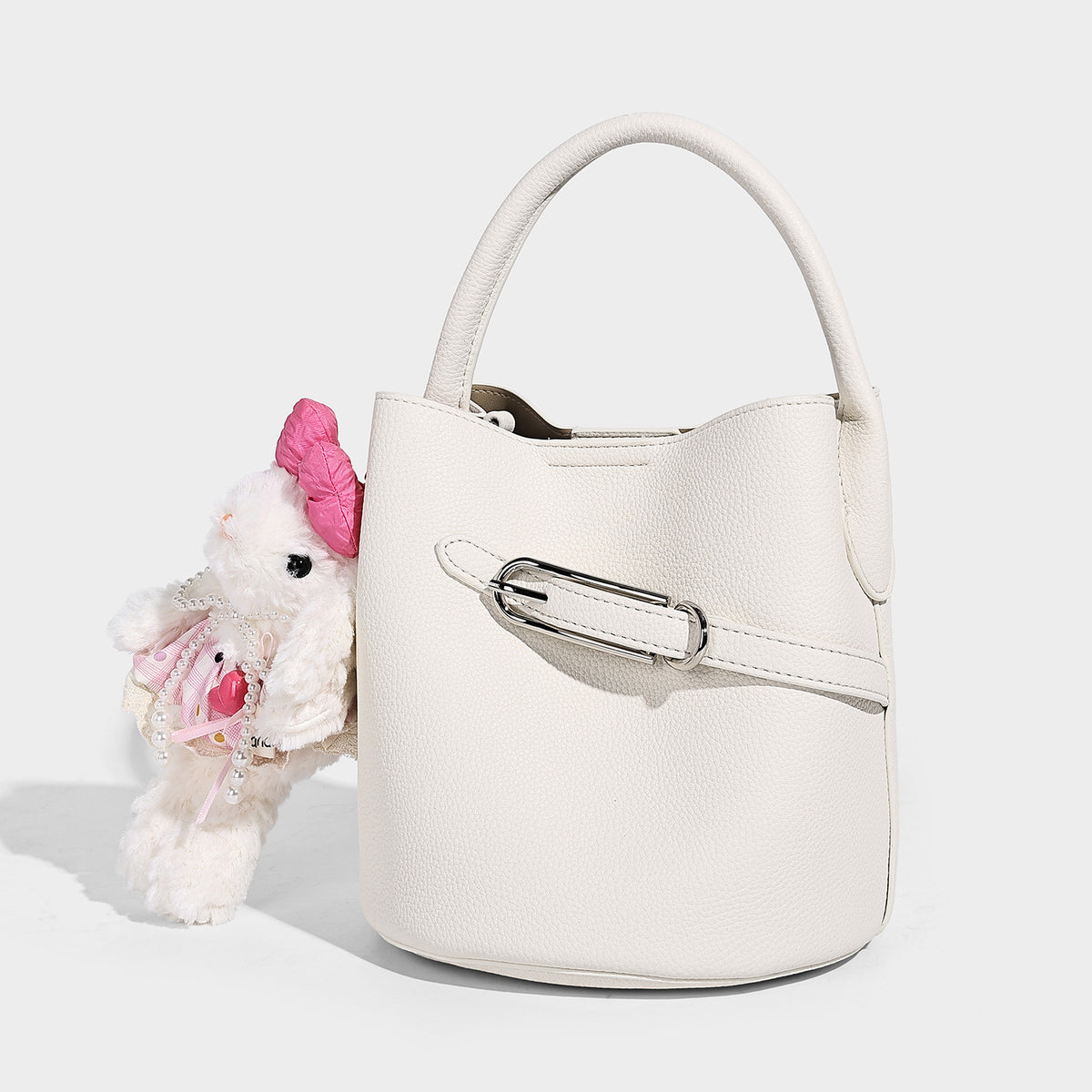 Mini pebbled leather-look bucket bag with front buckle strap, silver-tone hardware, top handle, and detachable shoulder
