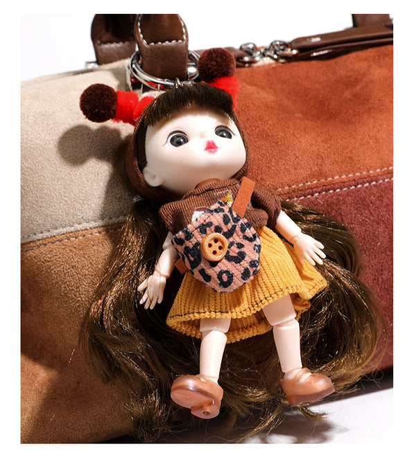 Patchwork suede-look barrel shoulder bag in brown, rust, tan, beige, and gray panels with double leather-look straps and