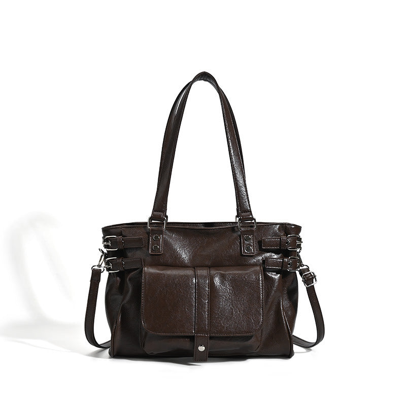 Large glossy leather-look tote bag with front flap pocket, silver-tone buckle hardware, dual top handles and detachable