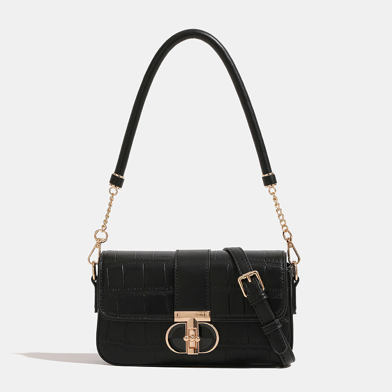 Small crocodile-embossed flap crossbody bag with circular gold turn-lock closure and chain strap, detail view 7