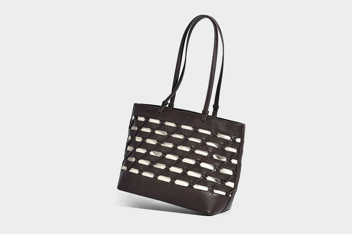 Structured woven lattice cutout tote bag with smooth leather-look trim, dual shoulder straps, and silver-tone hardware