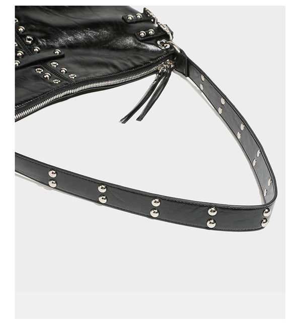 Black glossy leather-look slouchy shoulder bag with silver stud and eyelet hardware, top zip closure, front zip pocket, and