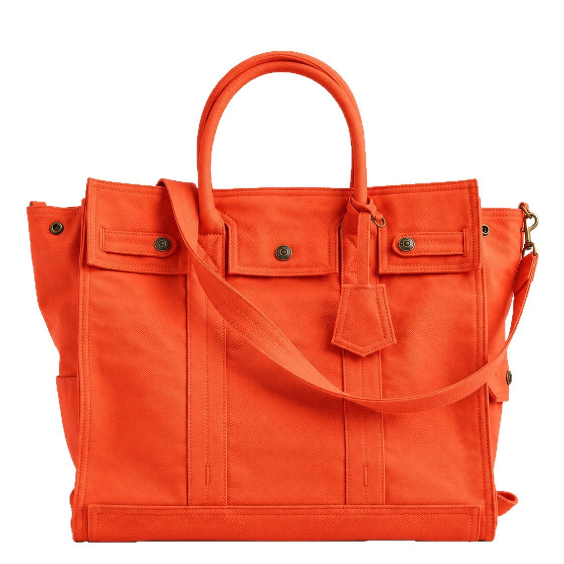 Large washed denim patchwork tote bag with snap-flap front pockets, rolled handles, and detachable shoulder strap, detail