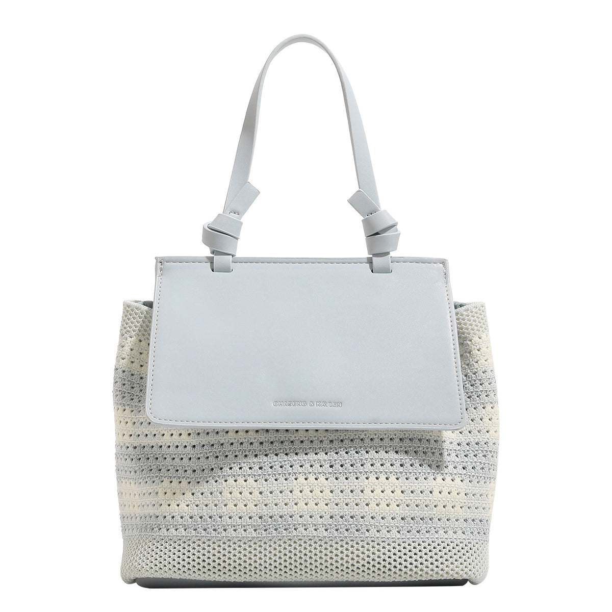 Small structured woven-body flap bag with smooth leather-look front panel, knotted top handle, and wide adjustable shoulder