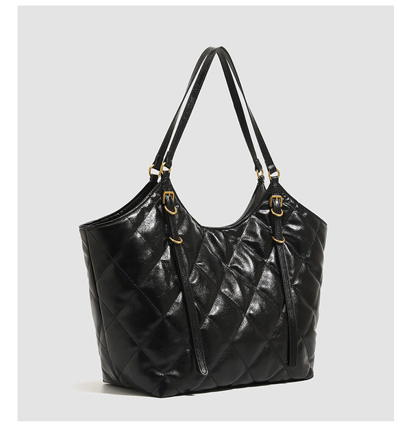 Large quilted diamond-pattern tote bag with glossy leather-look finish, dual flat shoulder straps, and gold-tone hardware