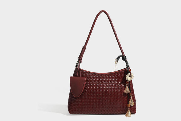 Woven-texture hobo shoulder bag in brown with braided top handle, adjustable crossbody strap, front flap pocket, and, detail