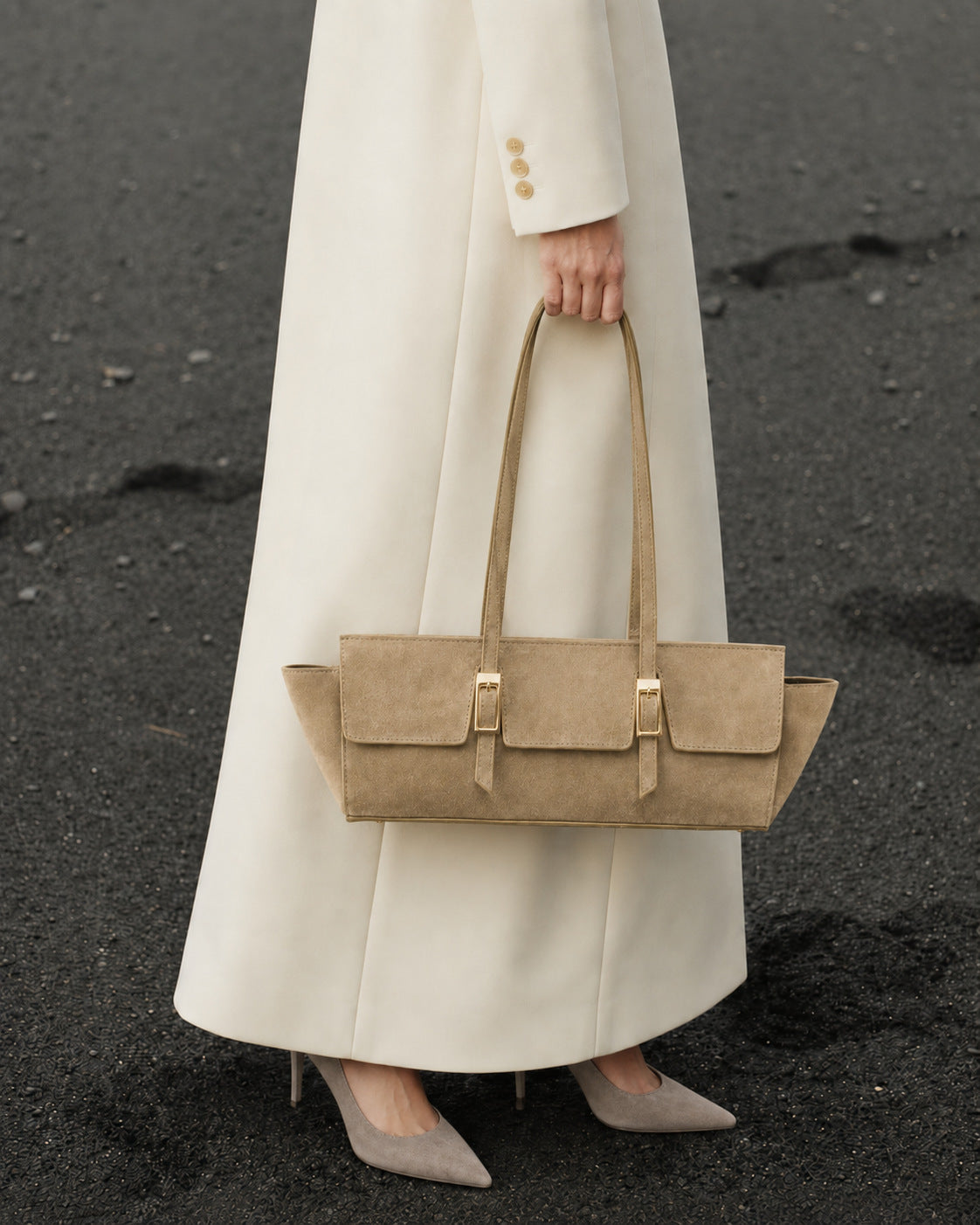 Wide trapezoid tote bag with matte suede-like finish, dual gold-tone buckle front pockets, and double flat shoulder straps