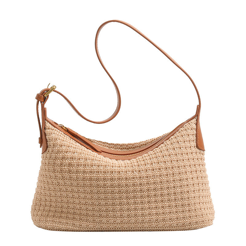 Beige woven raffia-style hobo shoulder bag with caramel leather-look trim, gold-tone zip closure, and adjustable strap