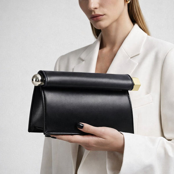 Structured rectangular clutch bag with rolled-top bar closure, gold-tone and silver-tone mixed metal hardware, front view