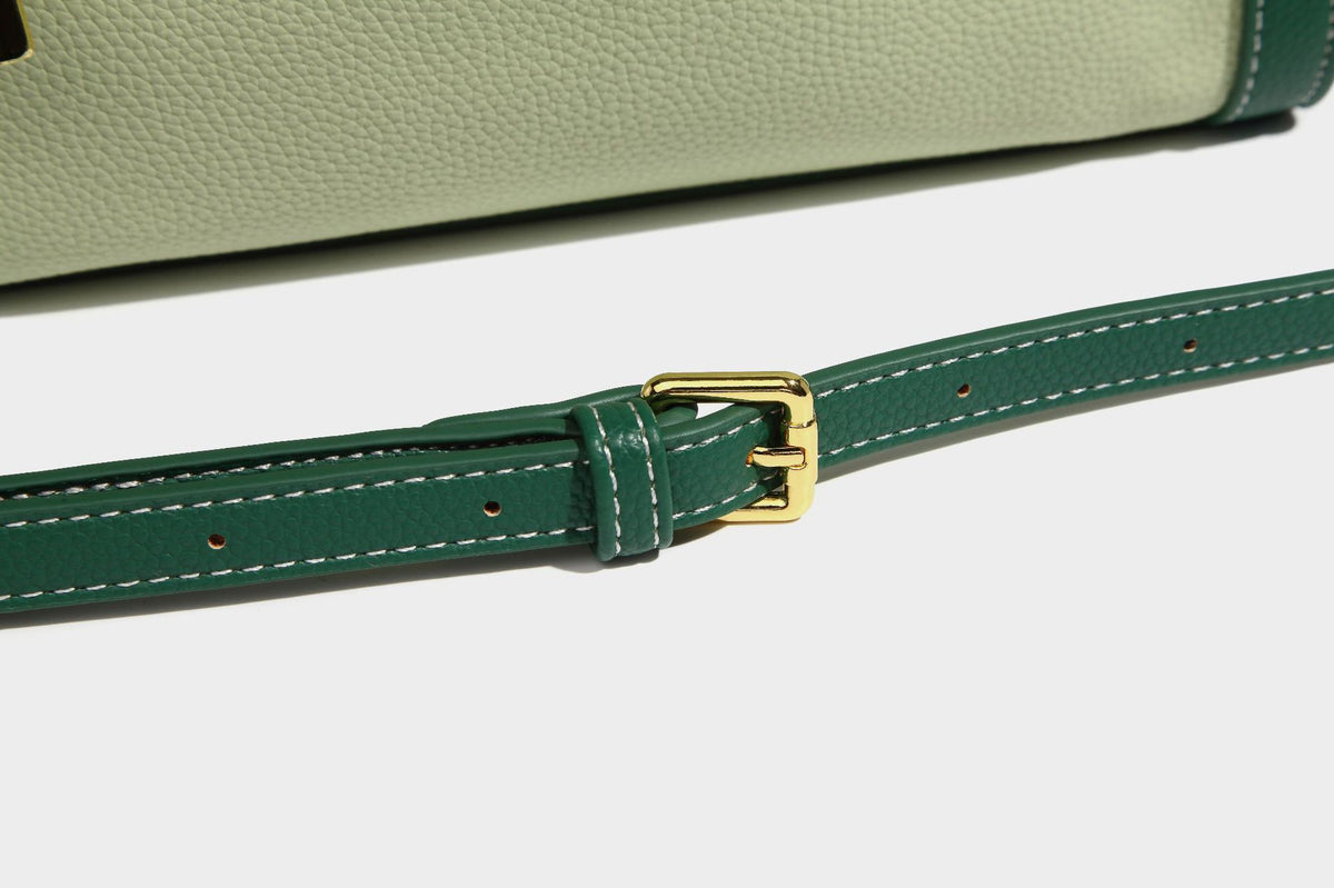 Structured two-tone shoulder bag with pebbled leather-look finish, contrast trim, top zip closure, and gold-tone hardware