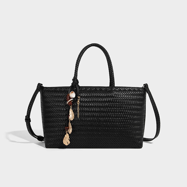 Structured woven-texture tote bag with brown braided top handles, decorative tassel charm, and detachable shoulder strap