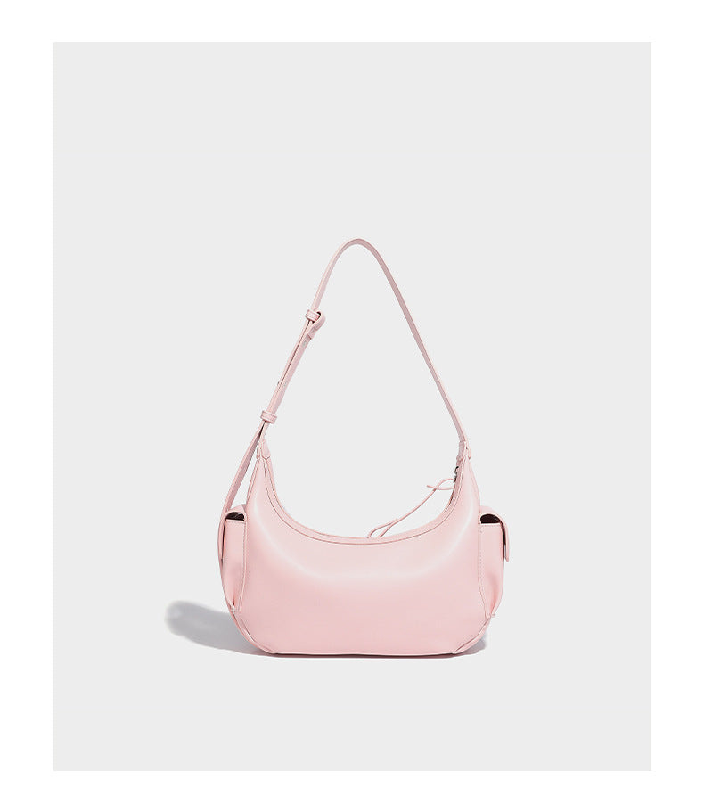 Smooth leather-look crescent shoulder bag with front zip pocket, side flap pockets, adjustable strap, and silver-tone, detail