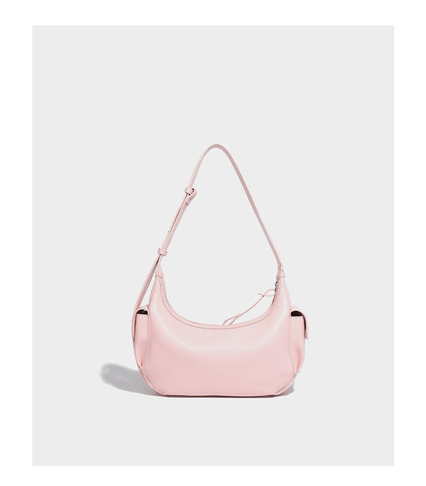 Smooth leather-look crescent shoulder bag with front zip pocket, side flap pockets, adjustable strap, and silver-tone, detail