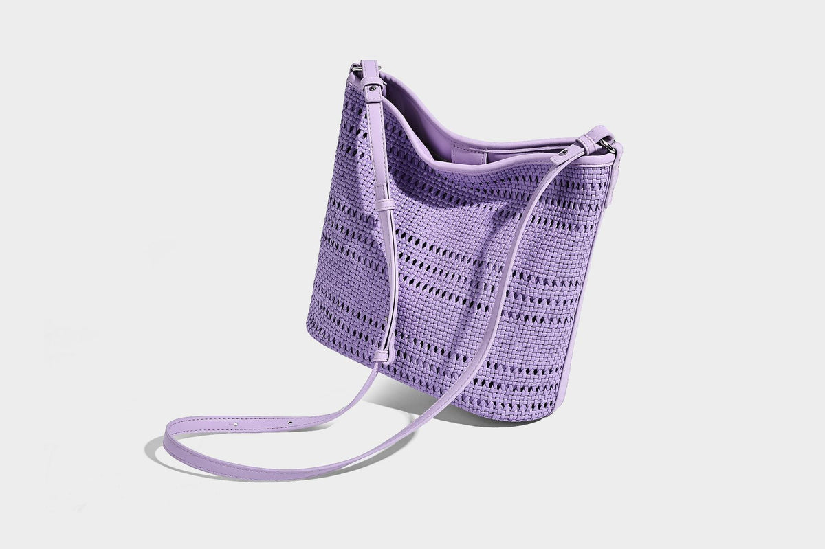 Handwoven open-weave shoulder bag with leather-look trim, knotted adjustable strap, and clip-on sunglasses sleeve pouch