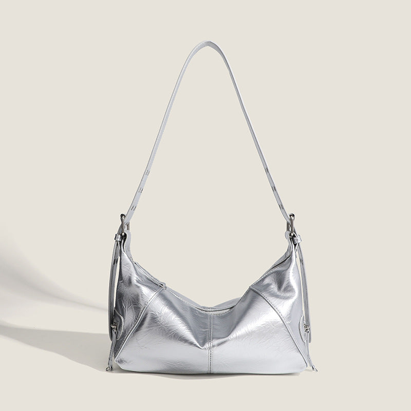 Glossy crinkled mini hobo shoulder bag with studded adjustable strap and silver-tone hardware, front view