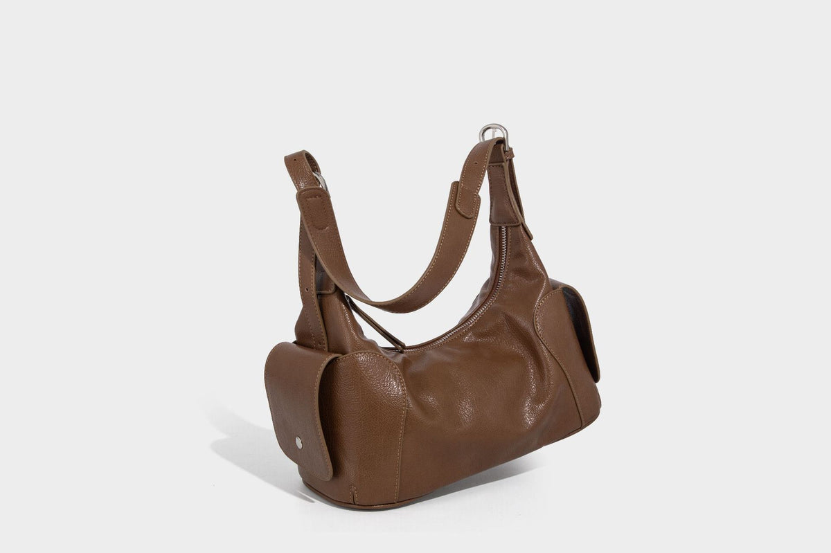 Soft pebbled leather-look hobo shoulder bag with zip top closure, side flap pockets, and silver-tone hardware, detail view 29