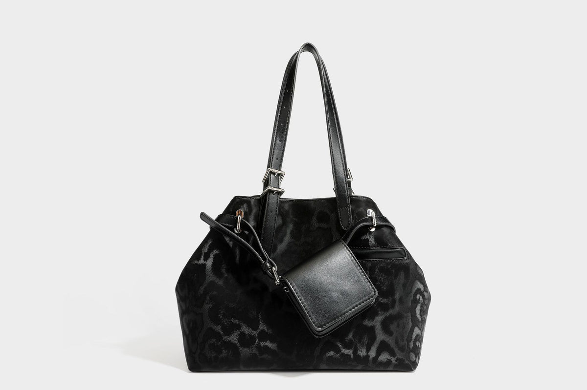 Glossy leopard-print tote bag with leather-look dark trim, dual top handles, detachable shoulder strap, and attached front