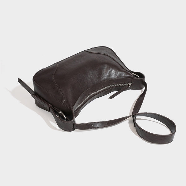 Dark brown curved zip-top hobo shoulder bag with slim adjustable strap and silver-tone hardware, detail view 4