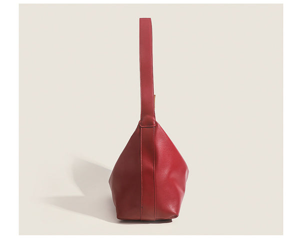 Large slouchy hobo shoulder bag in smooth leather-look finish with single long strap and gold-tone zip closure, detail view