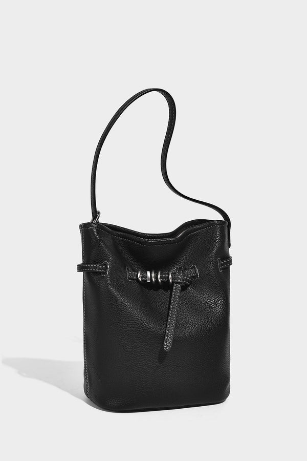 Small pebbled leather-look bucket bag with front drawstring toggle hardware and long adjustable shoulder strap, detail view