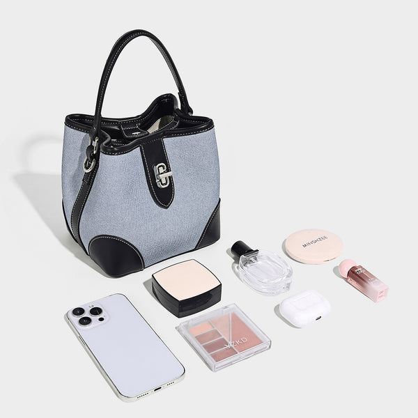 Small structured bucket bag in denim-look light blue fabric with black leather-look trim, silver turn-lock hardware, short