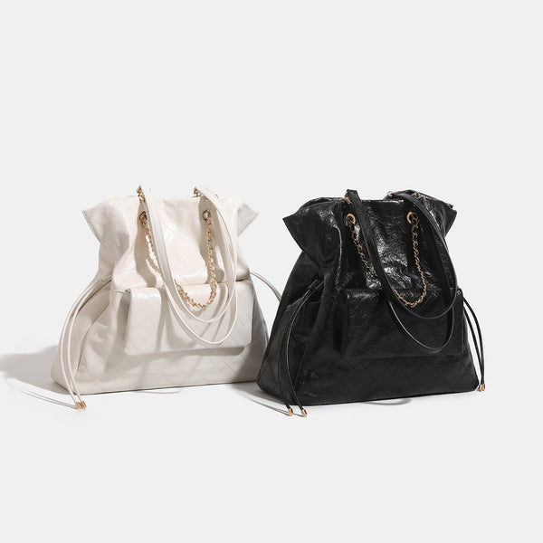 Quilted crinkled leather-look convertible tote backpack with gold-tone chain handles and drawstring closure, detail view 2