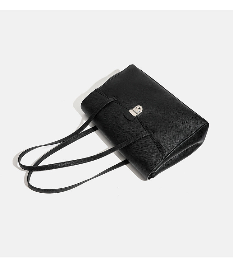 Structured black pebbled-finish flap tote bag with silver turn-lock clasp and long double shoulder straps, detail view 9